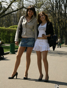 Two teens in stockings walking in the park