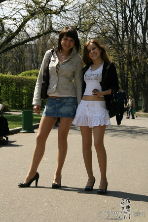 Two teens in stockings walking in the park